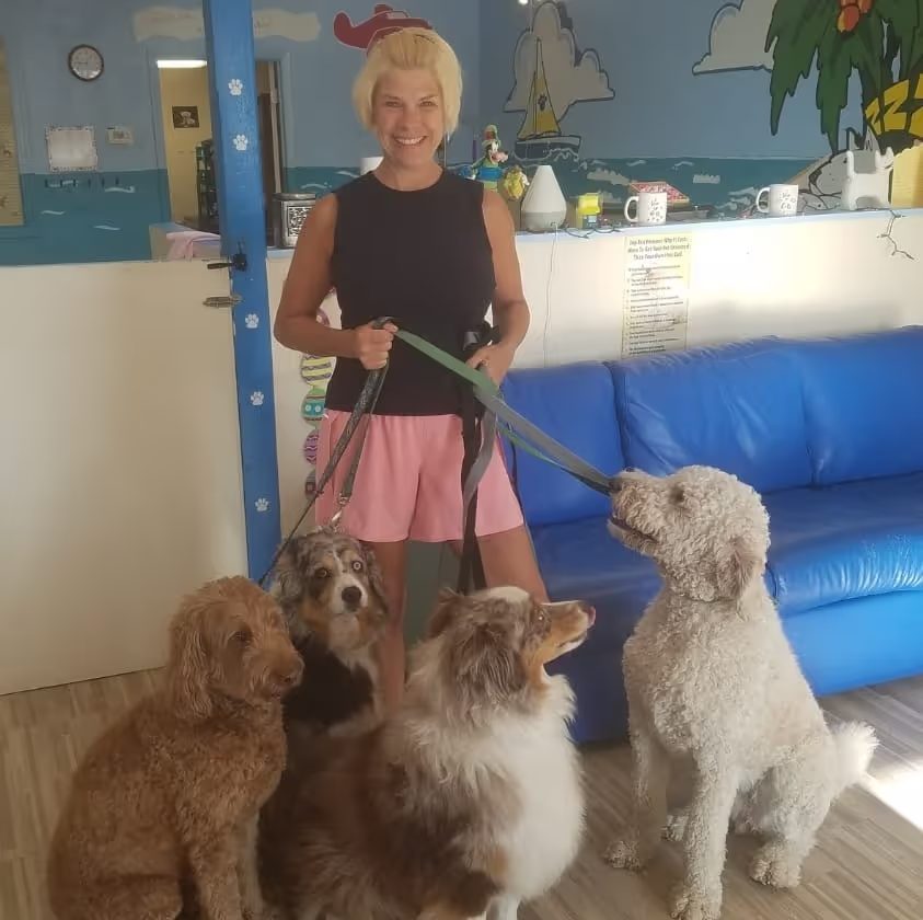 Diane with four happy dogs at Diane's PawFections